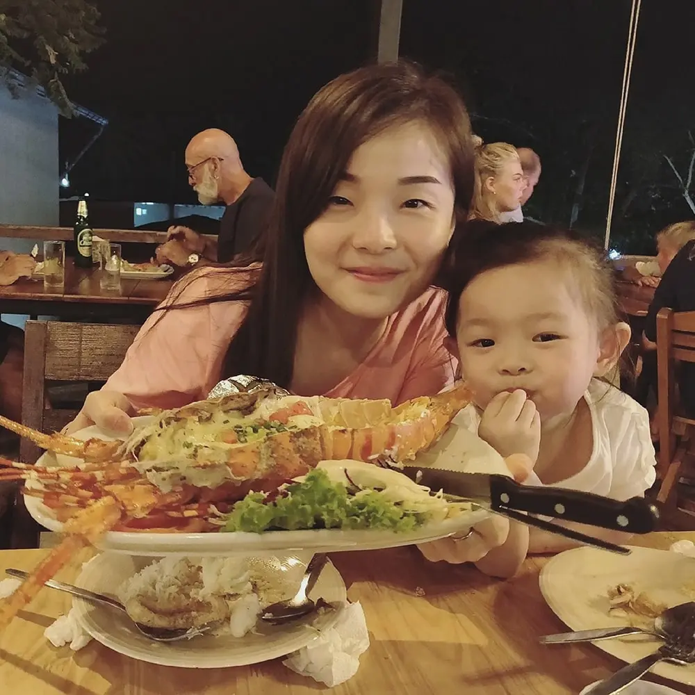 a person and a child sitting at a table with food | Top Lead Generation Agency